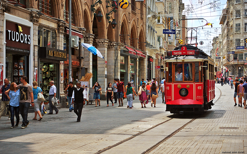 A picture of stores and a nostalgic style tram of famous street Istiklal in Istanbul.